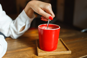 Red cup of coffee in a cafe on table. Place for rest