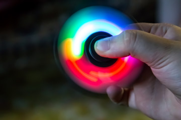 Fidget spinner toy with led light in hand