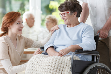 Smiling elder woman on wheelchair