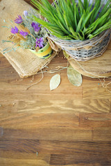 Grass and meadow flowers on old rustic wooden table