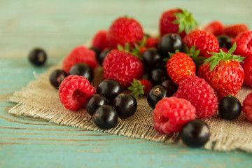 Berry of strawberries, raspberries and blackcurrants on the napkins from sackcloth on the...