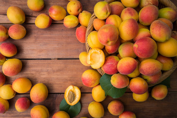 Fresh ripe apricots on a wooden table at the garden. Flat lay.