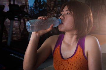 Young fitness players are drinking water.