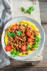 Tasty omelette with mushrooms, cherry tomatoes and parsley