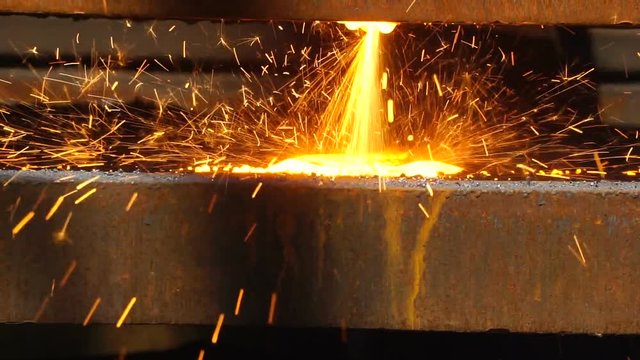 Worker Cutting Metal with a gas Flame torch in Metal industry close up metling
