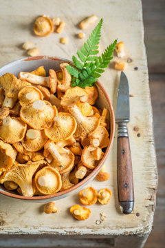 Raw chanterelles on old wooden rustic background
