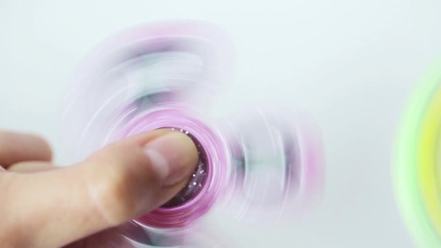 hand playing with spinning fidget spinner