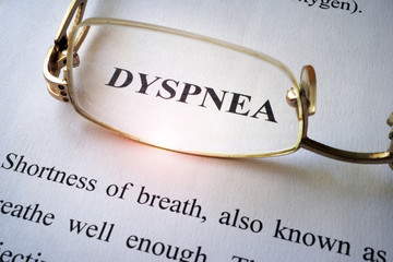 Paper with word dyspnea and glasses.