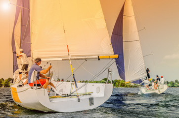 Sailing yacht race, regatta. Recreational Water Sports, Extreme Sport Action. Healthy Active Lifestyle. Summer Fun Adventure. Hobby. Team athletes participating in the sailing competition