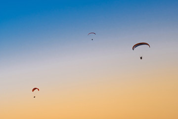Fototapeta na wymiar Paraglider in the sky at sunset