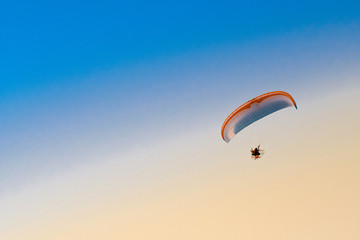 Paraglider in the sky at sunset