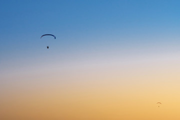 Paraglider in the sky at sunset