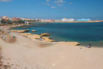 Sandy beach on coast of sea gulf. Porto-Torres, Italy
