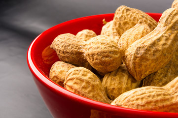 Peanuts in shell on dark background, close up