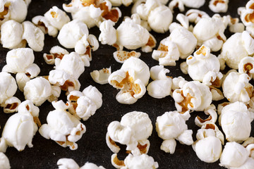 fresh popcorn close up on black table.