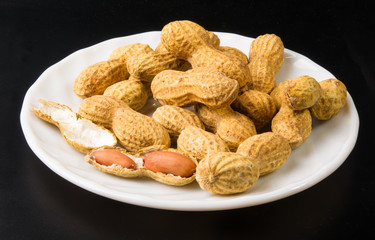 Peanuts in shell on dark background, close up
