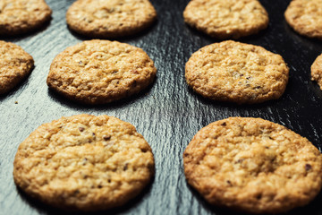 Biscuit sweet cookie background. Domestic stacked butter biscuit pattern concept,close up macro.Homemade cookies on wooden table.Cereal biscuits with the sesame,peanuts,sunflower and amaranth.