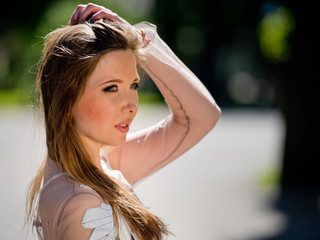 Naklejka premium Portrait of a young, attractive girl in the city area. Close-up.