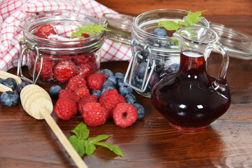 blueberries and raspberries in jars for the winter tea