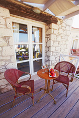 Hotel balcony with pool view, vine and fruits served