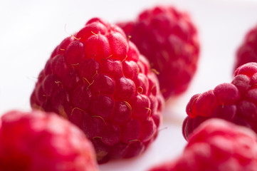 raspberries on a white saucer close up