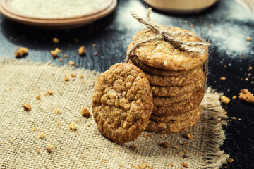 Biscuit sweet cookie background. Domestic stacked butter biscuit pattern concept,close up macro.Homemade cookies on wooden table.Cereal biscuits with the sesame,peanuts,sunflower and amaranth.