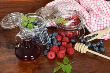 blueberries and raspberries in jars for the winter tea