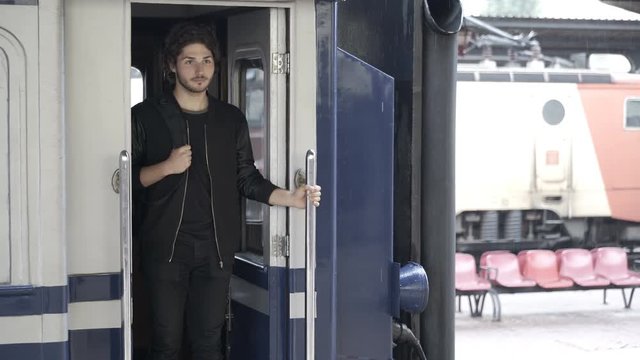 Attractive young woman rushing to hugging and saying goodbye to her boyfriend at the train station before leaving