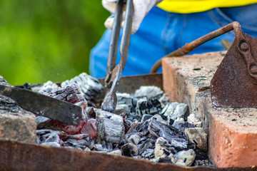 Coals in the smithy in the open air
