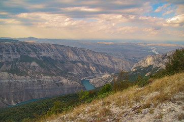 Fototapeta premium Scenic view of the mountains of the Caucasus and valley of the green-blue river in beams of the evening sun. Nature and travel. Russia, Dagestan, Sulaksky Canyon