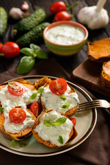 Baked sweet potatoes served with tzatziki dip.
