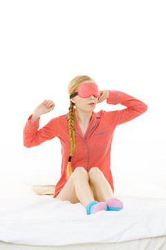 Sleepy woman wearing pink eye band