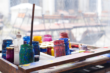 Color jars and tempera on working table in ceramic laboratory in turkey