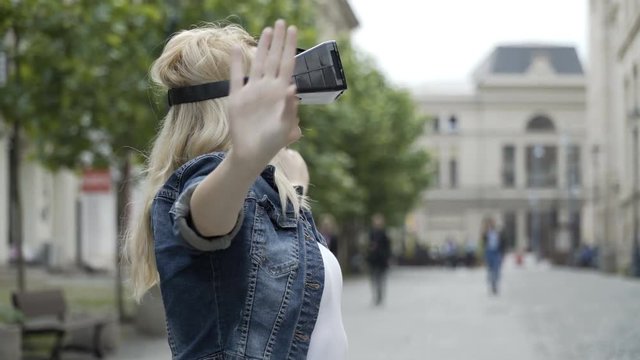 Blonde teen girl dancing ballet using virtual reality googles