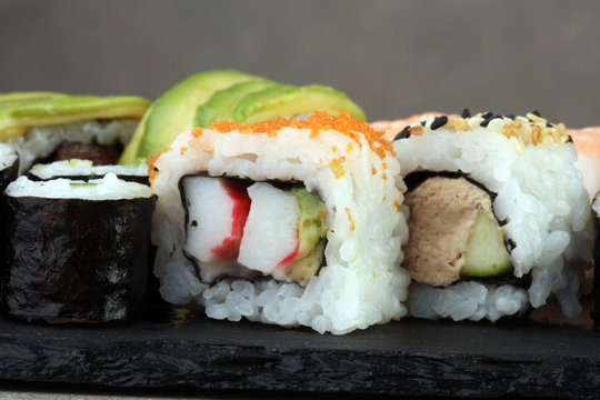 close up of sashimi sushi set with chopsticks and soy - sushi roll with salmon and sushi roll with smoked eel, selective focus.