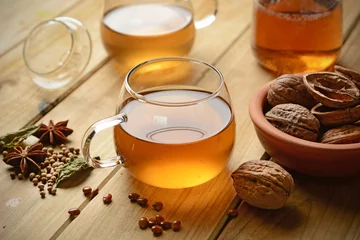 Acrylic prints Herbal tea with walnuts and ingredients around