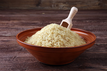 rice, indian basmati, pakistani basmati uncooked on brown background