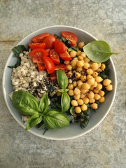 Fototapeta na wymiar The concept of healthy vegetarian food. Cooked pearl barley and chickpeas, cabbage kale and tomatoes. Buddha bowl.