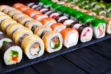 Great assortment of tasty multicolored maki sushi rolls, selective focus. Sushi restaurant concept