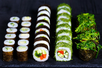 Vegetarian sushi menu. Rolls with cucumber, futomaki with vegetables and gunkan sushi with chuka...