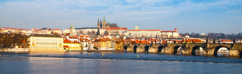 Fototapeta premium Prague Hradcany Panorama on sunny day. Charles Bridge over Vltava River with Prague Castle, Czech Republic.