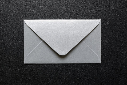silver envelopes on black background