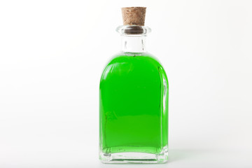 Glass bottle with green liquid.