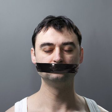 man with duck tape on face