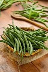 Pile of green beans on wooden table