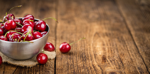 Fresh Cherries on vintage wooden background
