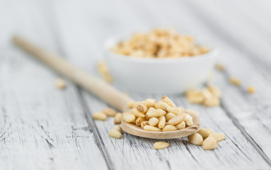 Wooden table with Pine Nuts (selective focus)