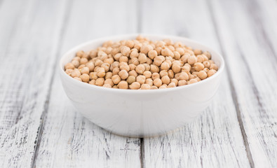 Dried Chickpeas on wooden background; selective focus
