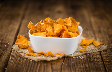 Sweet Poto Chips on wooden background; selective focus