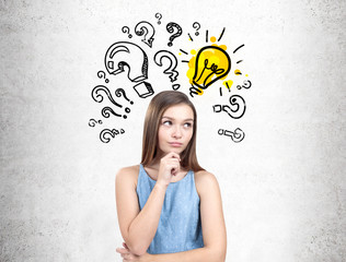 Pensive teen girl in a dress, questions and a bulb